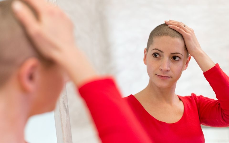 Woman with shaved head preparing for chemotherapy